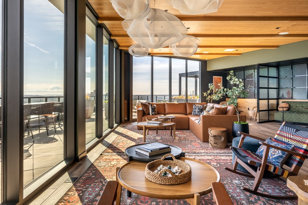 A living room with a view of the ocean through large windows.