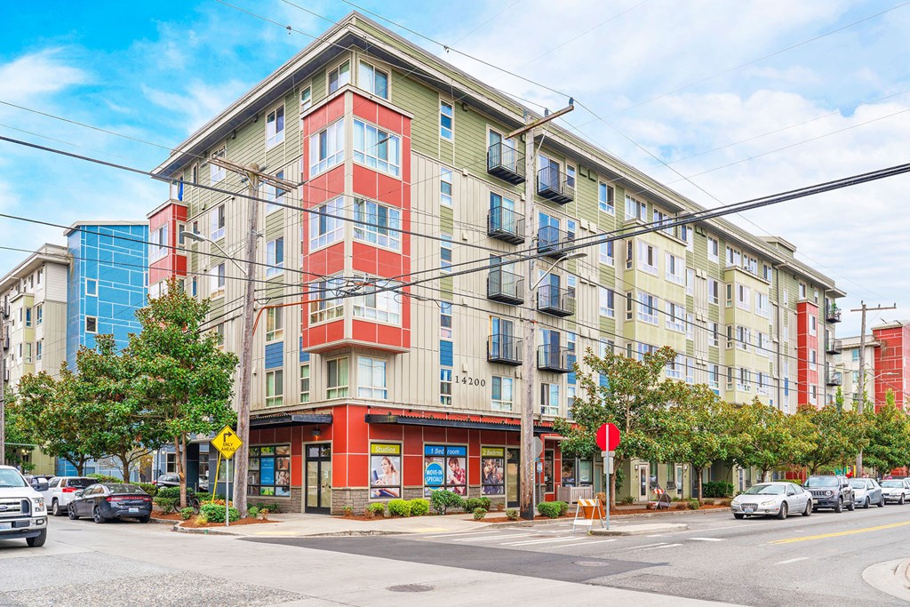 a large apartment building on a city street with cars