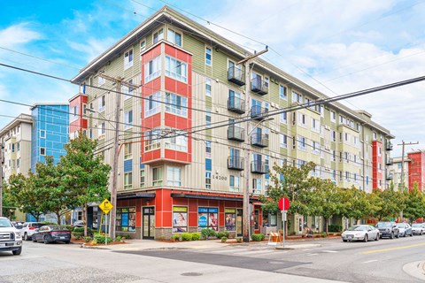 a large apartment building on a city street with cars