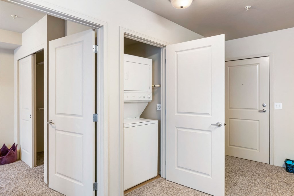 the closet in a bedroom of a home with white doors