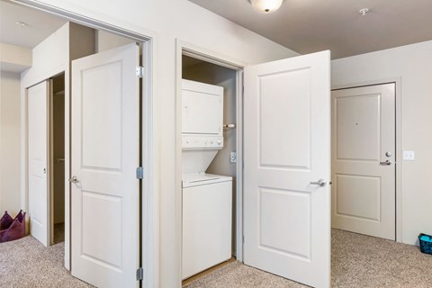 the closet in a bedroom of a home with white doors