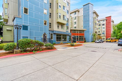 an empty street in front of an apartment building
