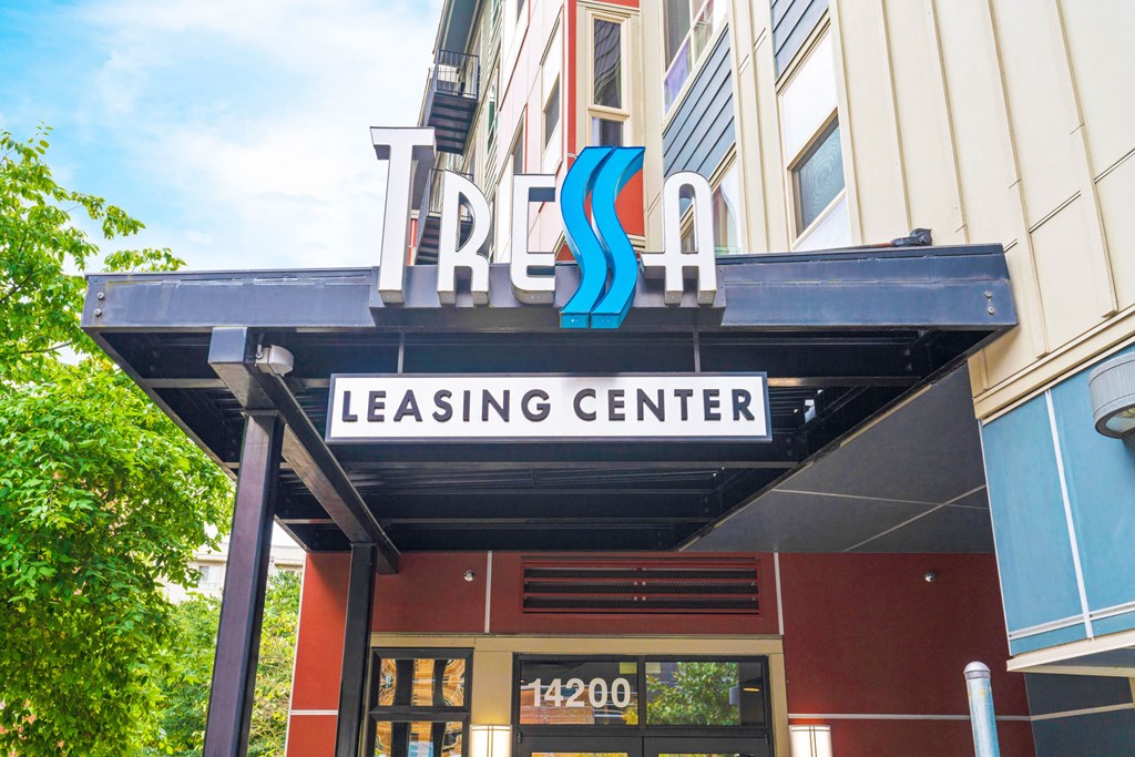 the outside of a leasing center with a sign on the building