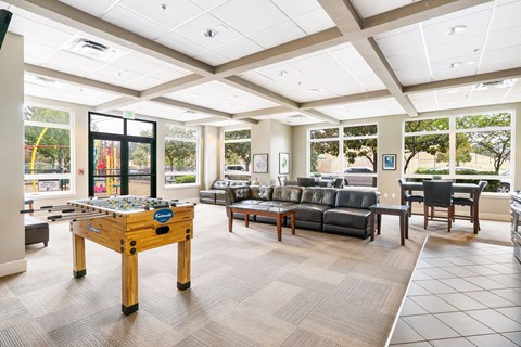 a game room with a pool table and couches