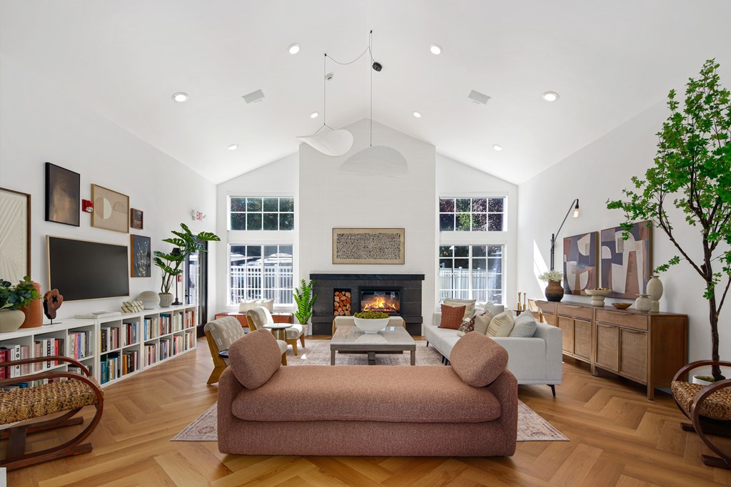 A living room with a fireplace, a couch, and a chair.