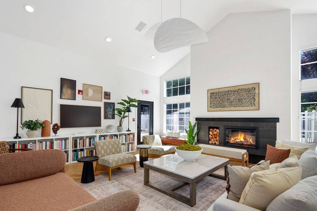 A living room with a fireplace and a television.