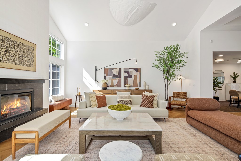 A living room with a fireplace and a large painting on the wall.