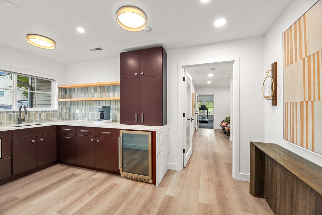 A kitchen with wooden floors and brown cabinets.
