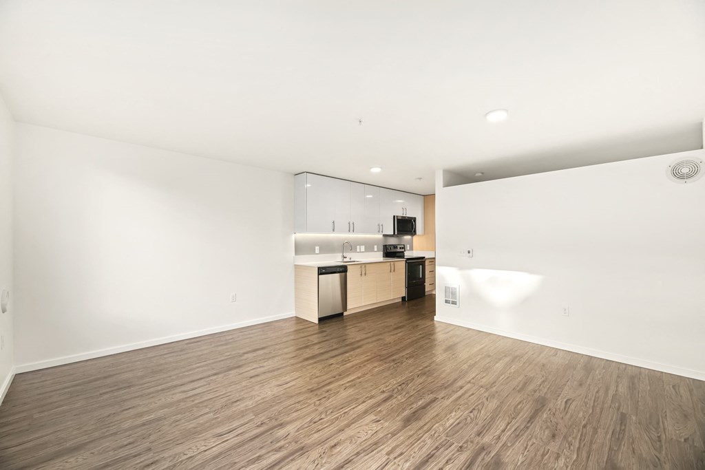 A kitchen area with a refrigerator, oven, and sink.