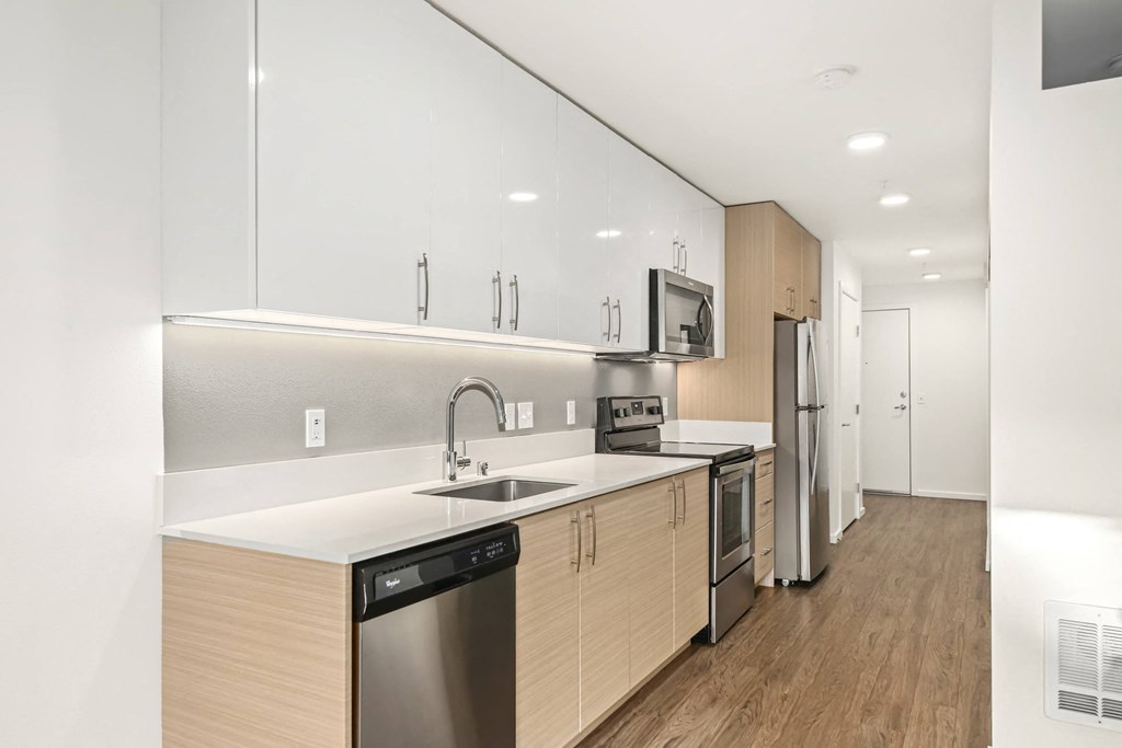 A modern kitchen with wooden cabinets and stainless steel appliances.