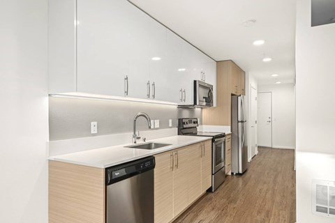 A modern kitchen with wooden cabinets and stainless steel appliances.