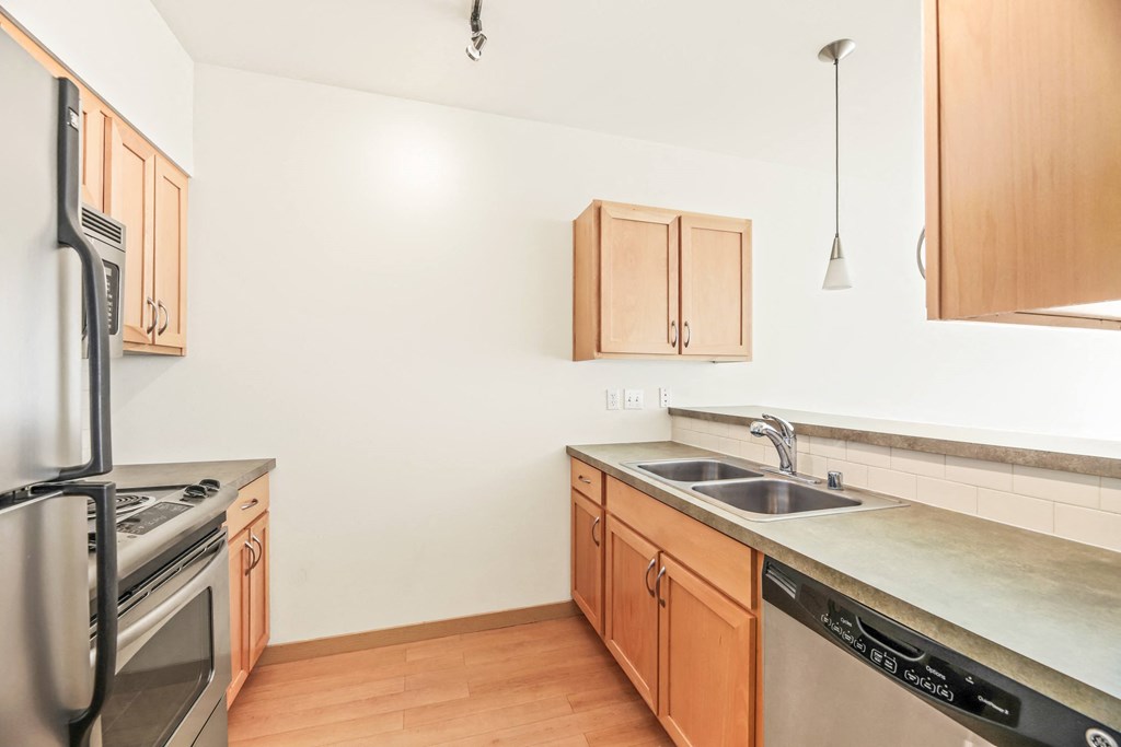 a kitchen with stainless steel appliances and wooden cabinets