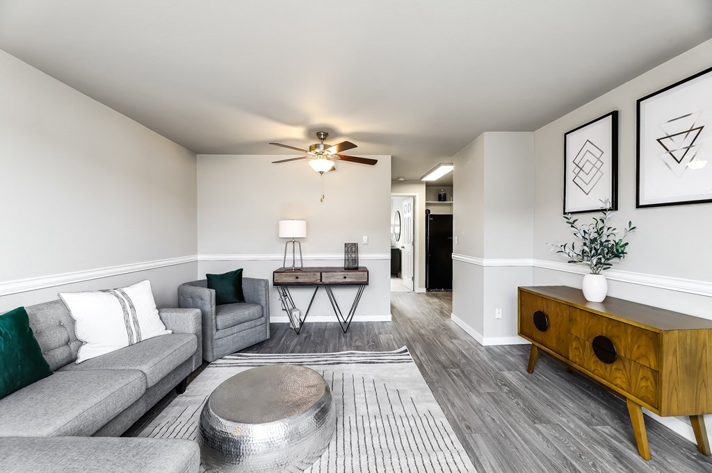 a living room with gray couches and a coffee table