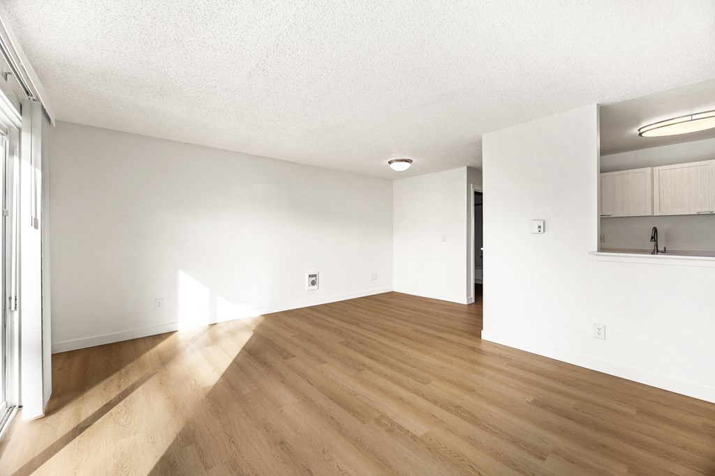 A room with wooden floors and white walls.