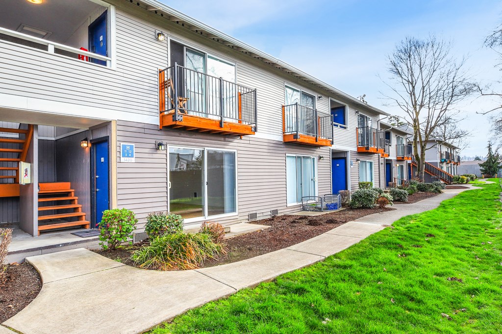 A row of townhouses with blue doors and windows.