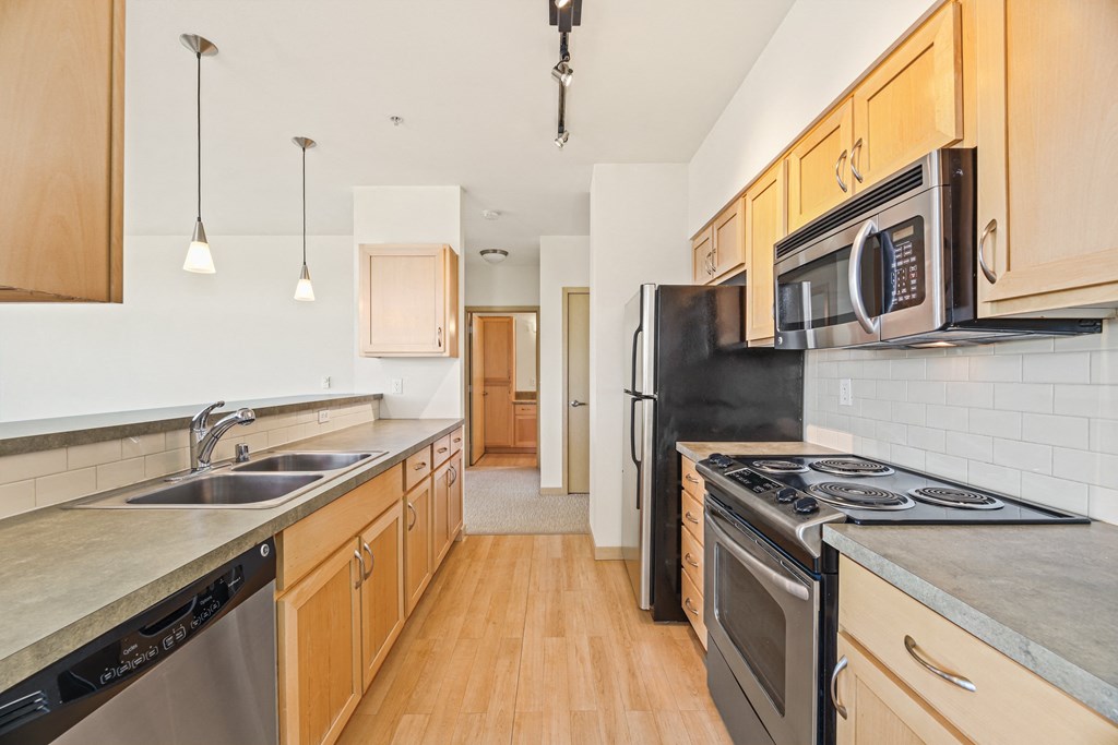 a kitchen with stainless steel appliances and wooden cabinets