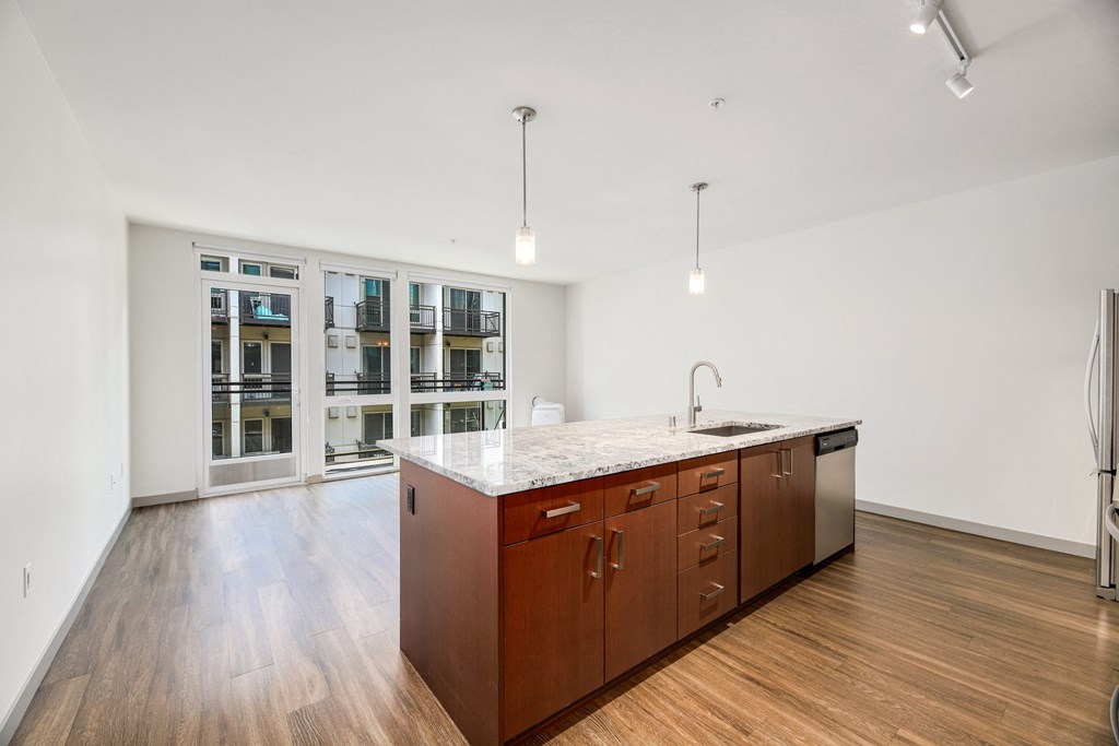 a large kitchen with wood floors and a large island in the middle