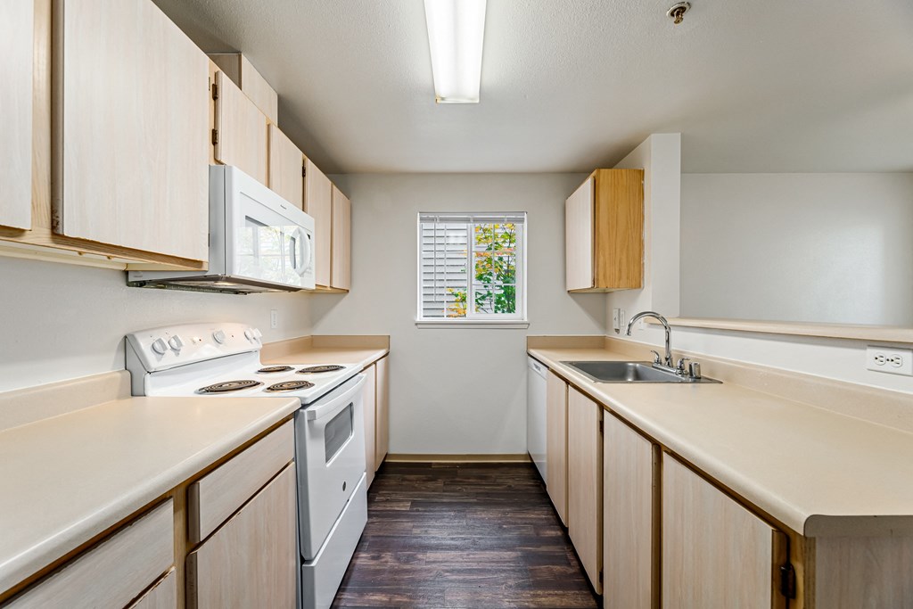 a kitchen with white appliances and wooden cabinets