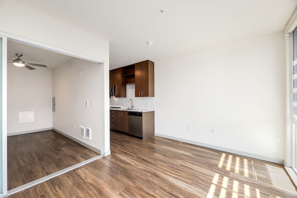 an empty living room and kitchen in a new home