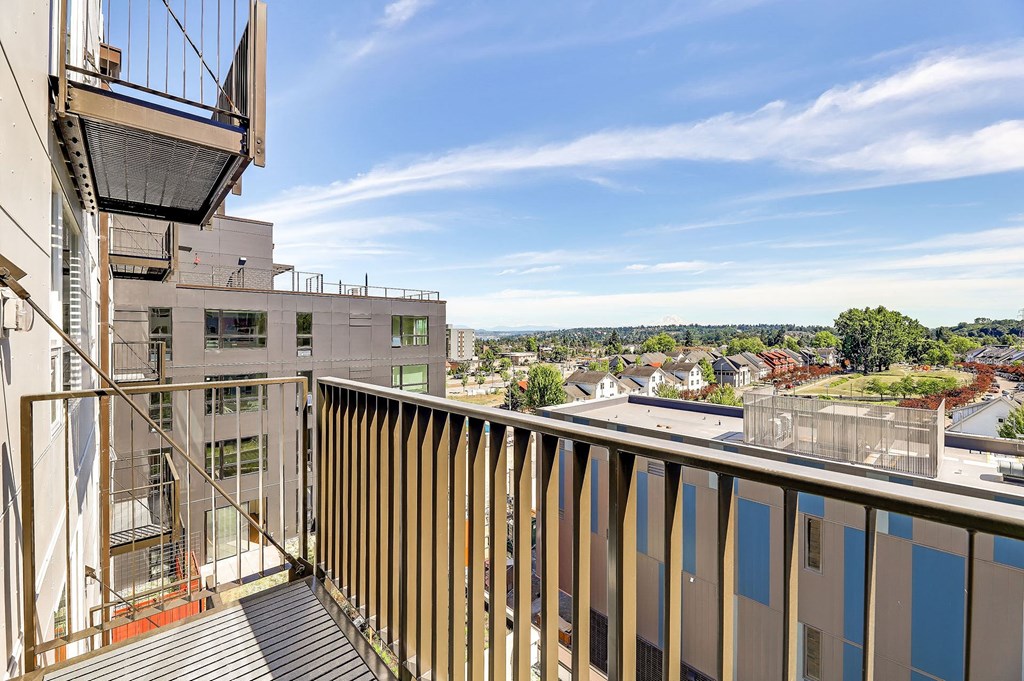 a balcony with a view of a city and a blue sky