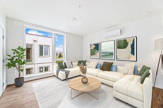 a living room with a couch and a table     and a window