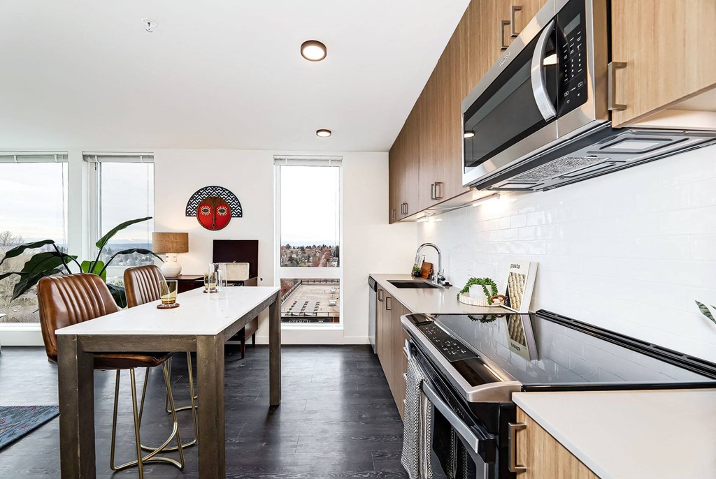 a kitchen with a table and a stove and a microwave