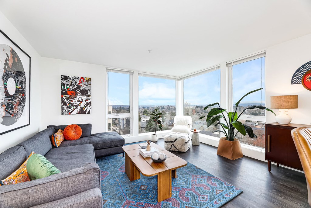 a living room with couches and a table and a large window