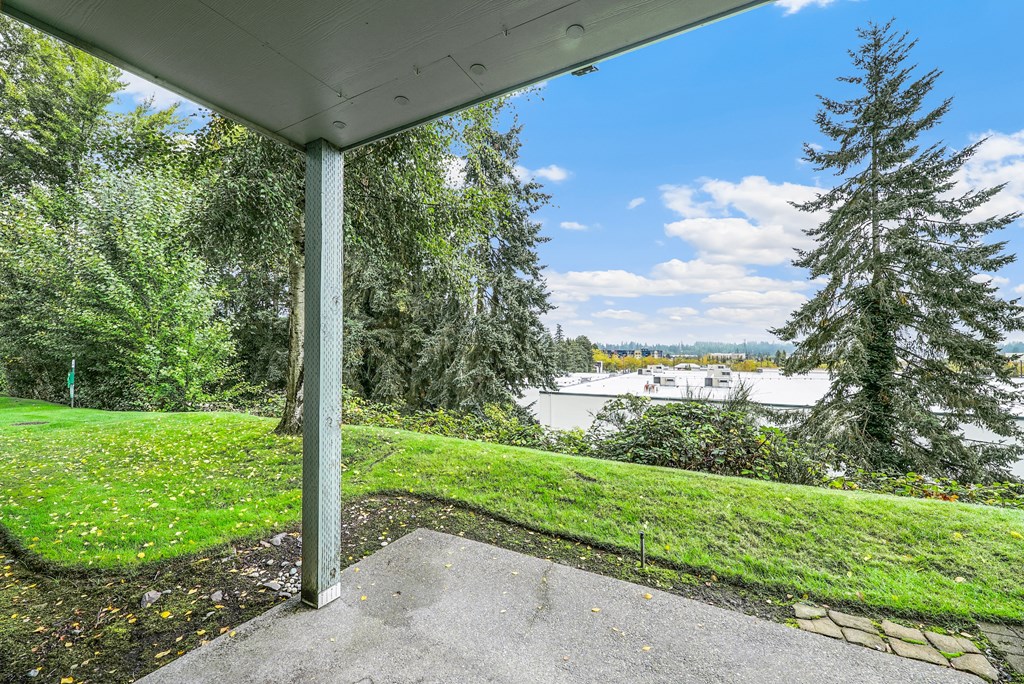 a porch with a view of a lake and trees
