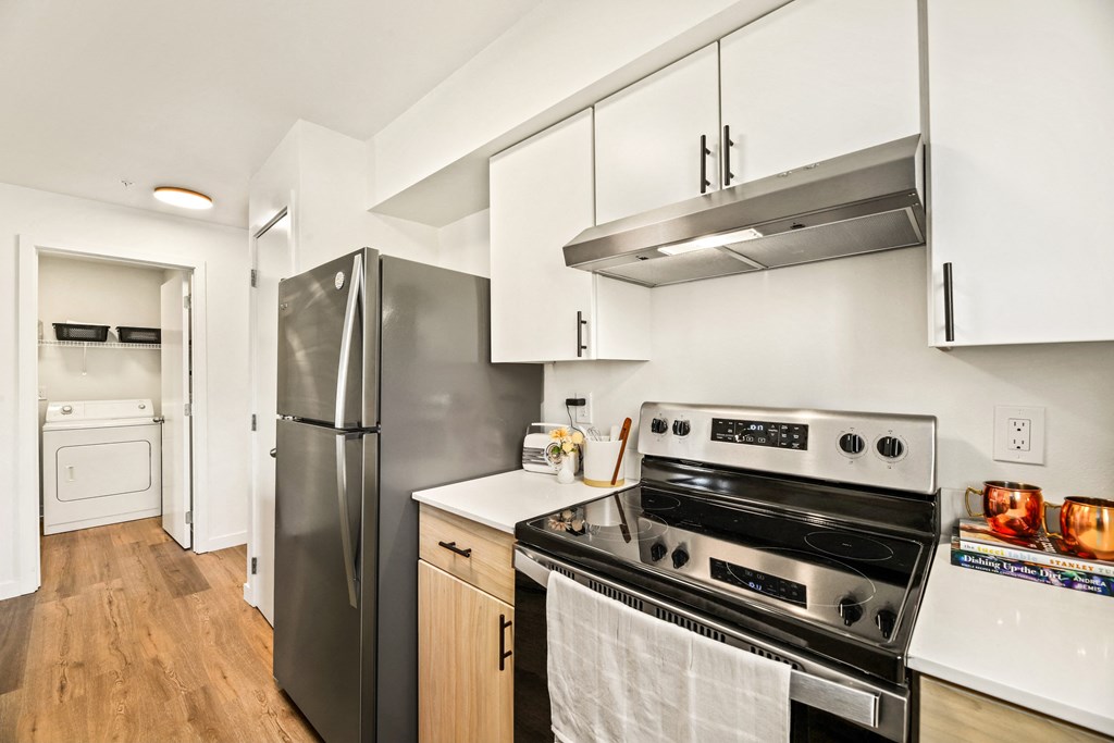 a kitchen with stainless steel appliances and white cabinets