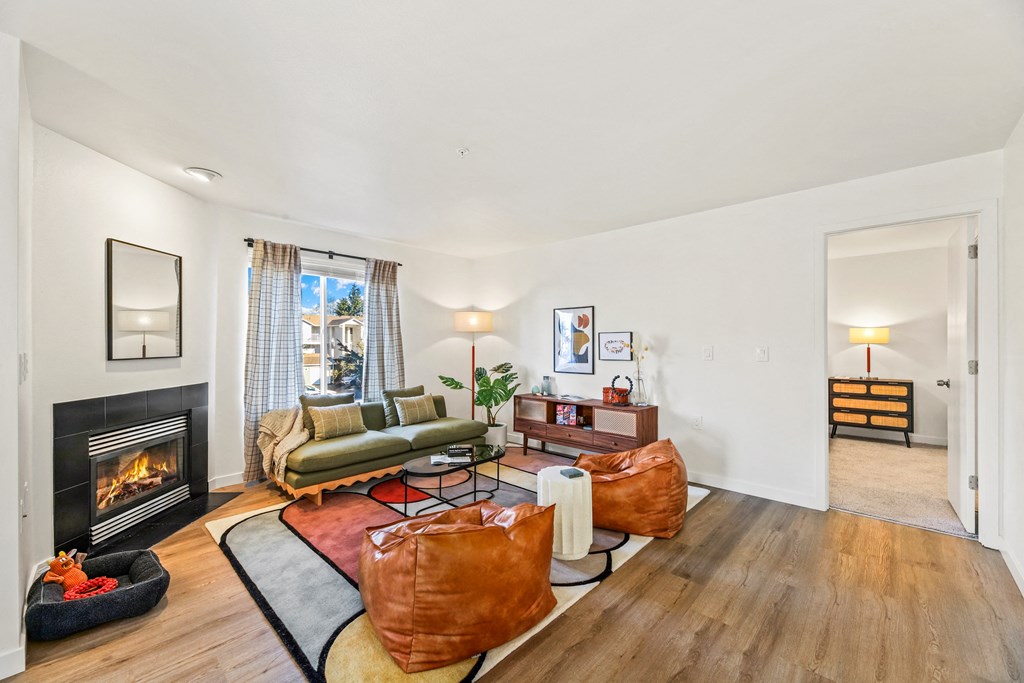 a living room with a fireplace and leather furniture