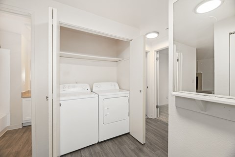 A white laundry room with a washer and dryer.