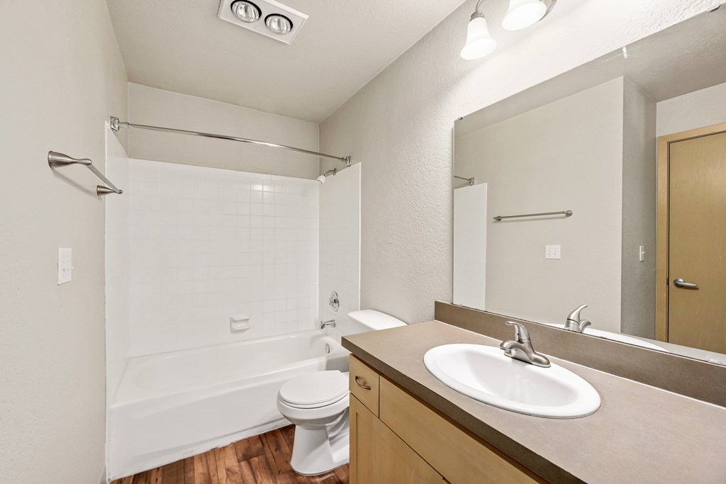 A white toilet sits next to a sink in a bathroom.