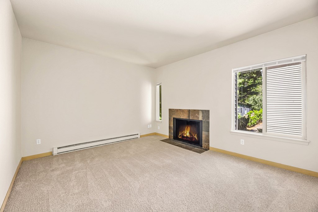 A room with a fireplace and a window with blinds.