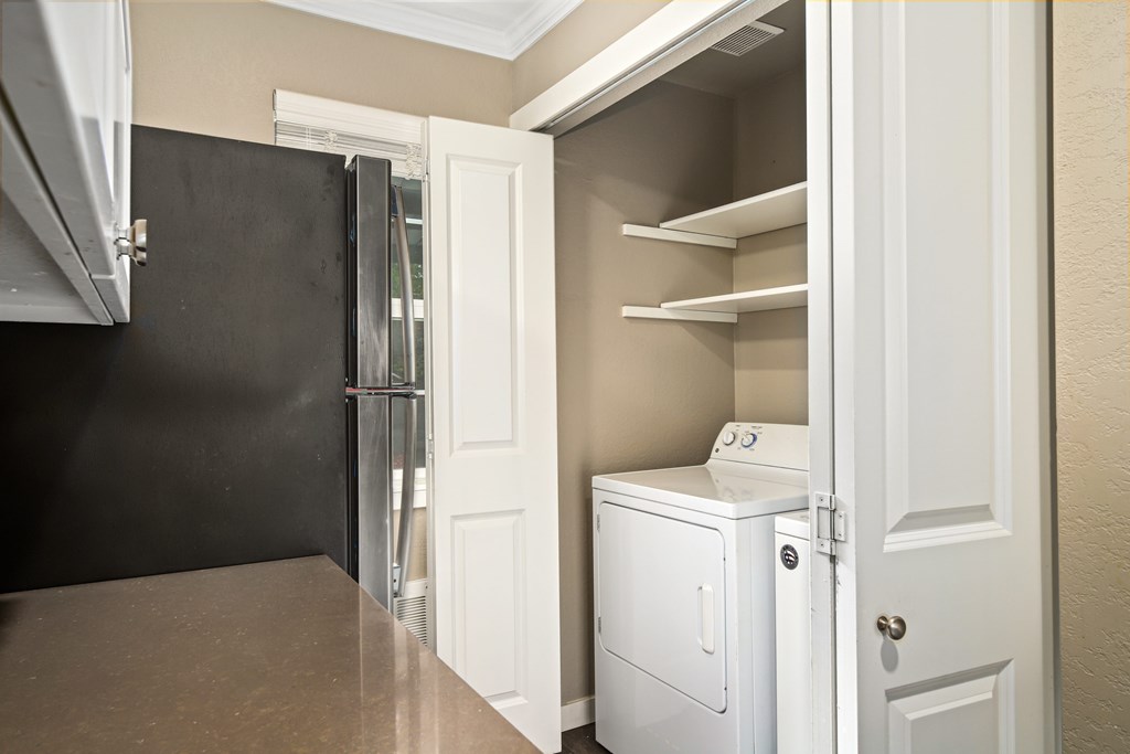 A small laundry room with a washer and dryer.