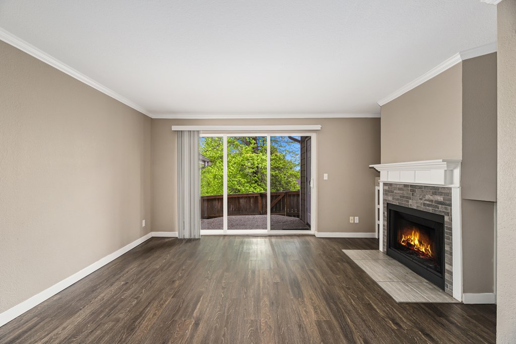 A room with a fireplace and sliding glass doors.