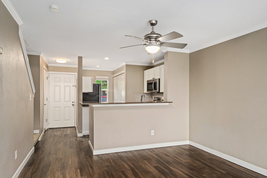 A room with a ceiling fan and a counter.