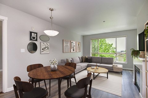 a living room with a couch and a table and a window