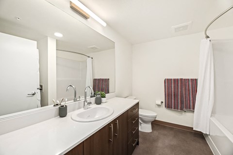 A white sink in a bathroom with brown flooring.