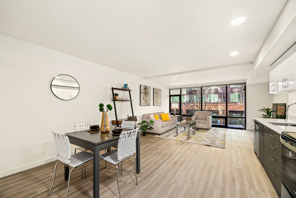 A modern kitchen and dining area with a table set for two.