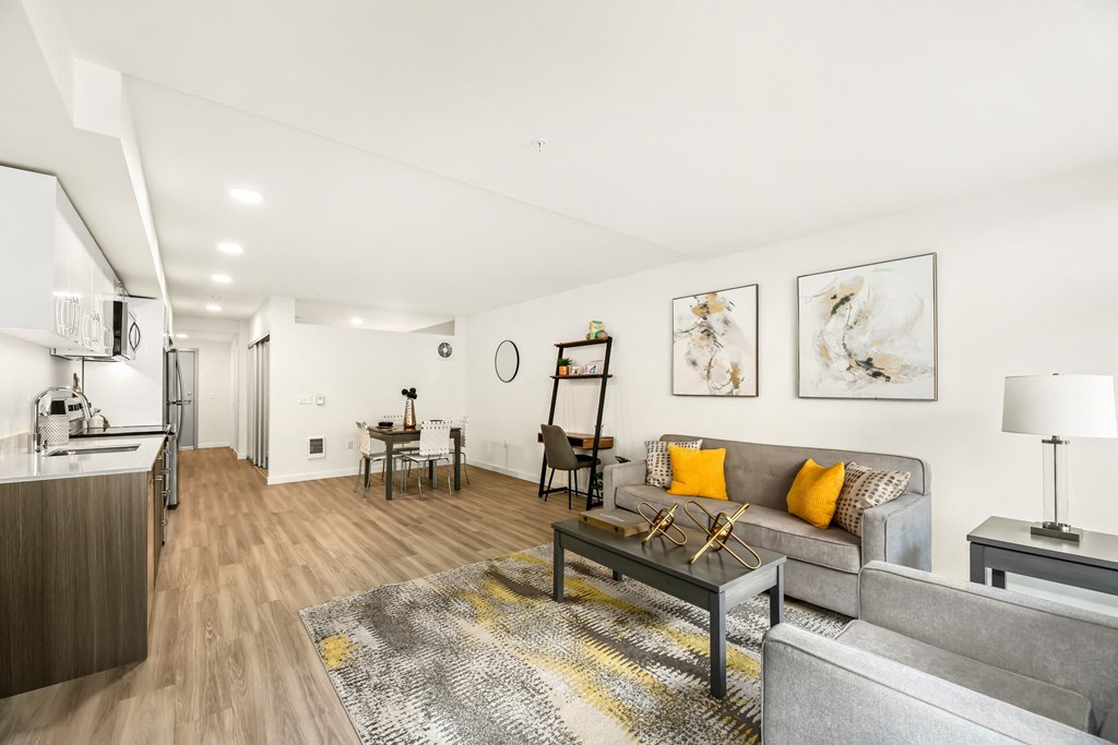 A living room with a grey couch and a coffee table.