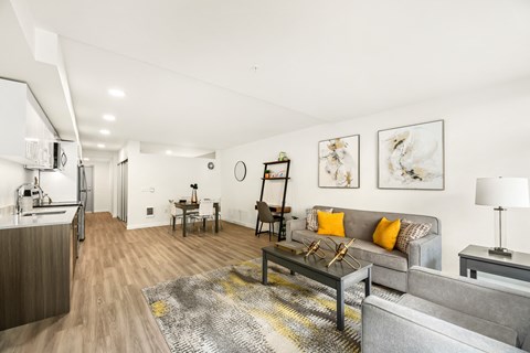 A living room with a grey couch and a coffee table.