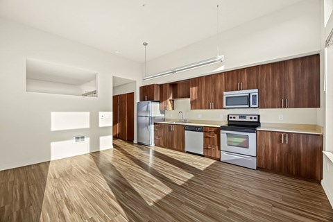 A kitchen with wooden floors and white walls.