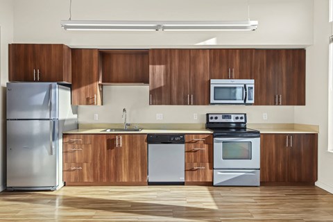 A modern kitchen with wooden cabinets and stainless steel appliances.