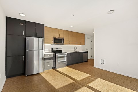 A modern kitchen with stainless steel appliances and wooden accents.