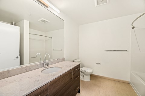 A bathroom with a sink, toilet, and bathtub.