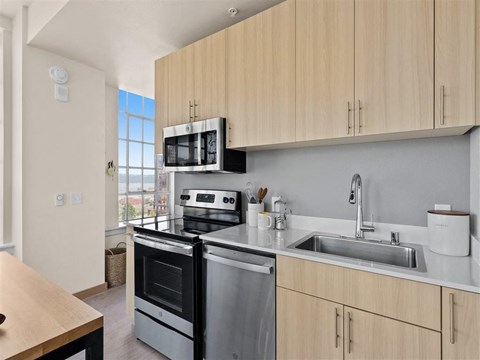 a kitchen with a sink and a stove and a window