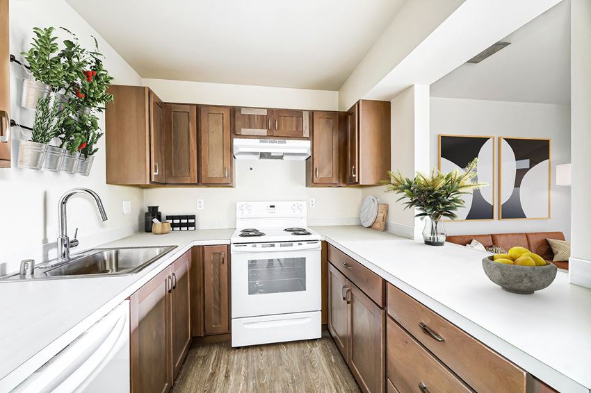 a large kitchen with white appliances and wooden cabinets