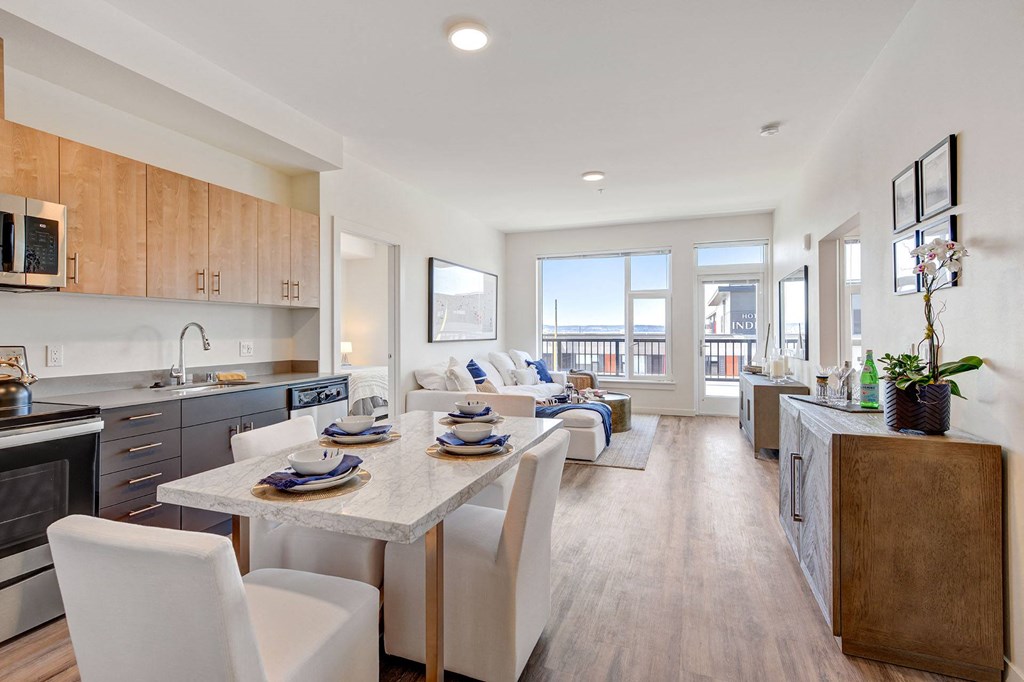 a kitchen and living room with a table and chairs