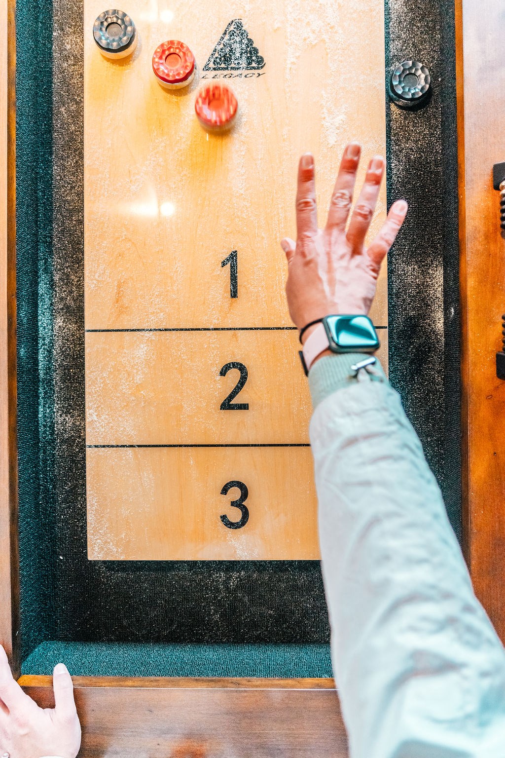 a hand reaching up to a ballot box