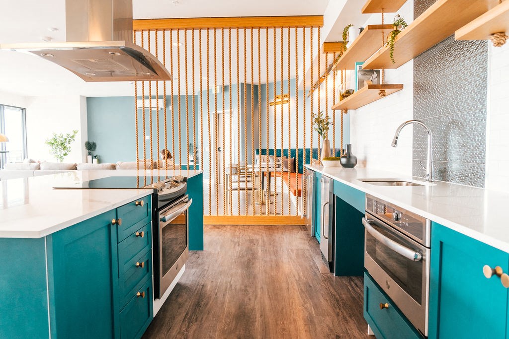a kitchen with blue cabinets and a sink and a stove